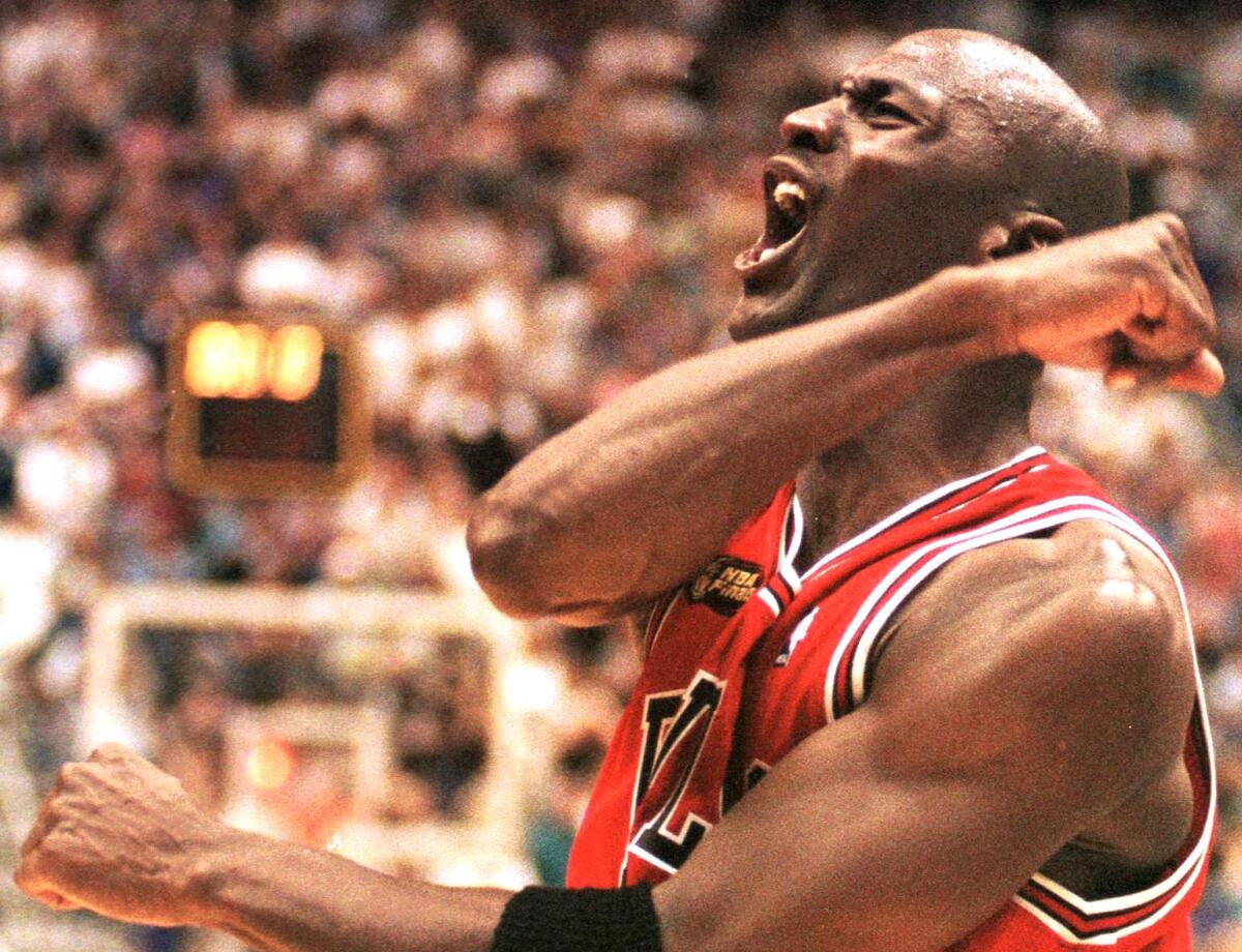 Michael Jordan celebrates after the Chicago Bulls clinched their sixth NBA title in 1998.