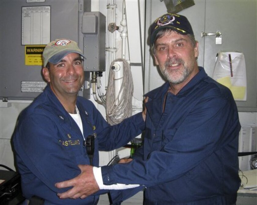 This Sunday, April 12, 2009 photo released by the U.S. Navy, shows Maersk-Alabama Capt. Richard Phillips, right, standing alongside Cmdr. Frank Castellano, commanding officer of the USS Bainbridge, after being rescued by U.S. Naval Forces off the coast of Somalia. (AP Photo/U.S. Navy photo)