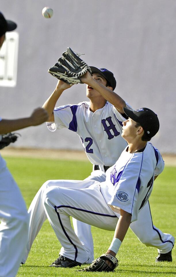 Hoover's Jonathan Ramos and Javier Cisceros both ran up on the shallow hit ball in the outfield with Ramos making the catch against Crescenta Valley in a Pacific League baseball game at Hoover High School in Glendale on Friday, March 29, 2013.