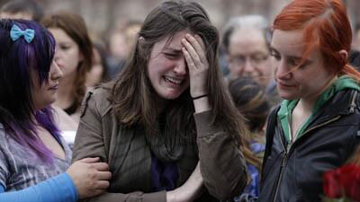 Emma MacDonald, 21, center, cries at the Boston Common vigil Tuesday for the victims of the marathon bombings.