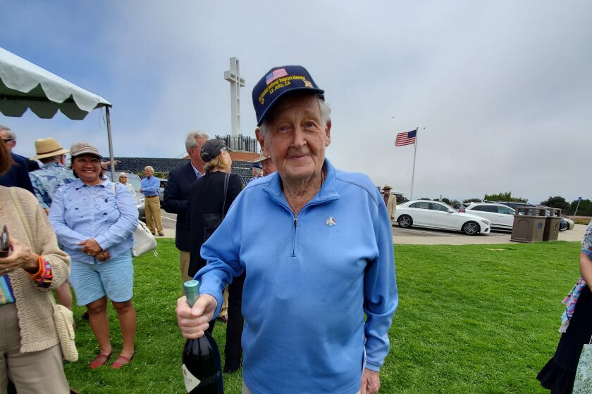 100-year-old Max Gurney holds a gifted bottle of wine at his birthday celebration June 30 atop Mount Soledad.