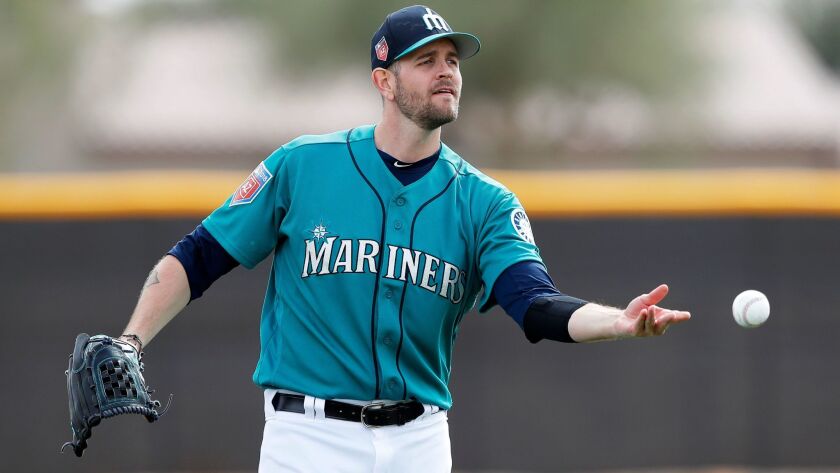 Mariners starting pitcher James Paxton tosses the ball to a teammate during a drill in a baseball spring training workout, Monday, Feb. 19, 2018, in Peoria, Ariz.