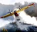 A super scooper air tanker drops water on a hillside in la Canada Flintridge in December, 1999.