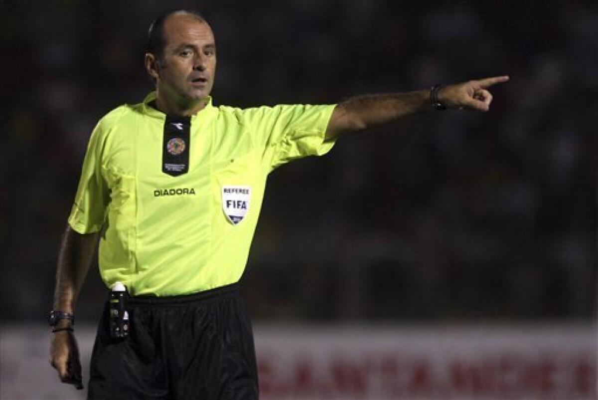 In this March 16, 2010 photo Brazil's referee Carlos Simon gestures during a Copa Libertadores soccer game between Peru's Alianza Lima and Peru's Juan Aurich in Chiclayo, Peru. The Brazilian referee and his assistants who will work the England-United States match at the World Cup have been studying English-language obscenities the players might use. Carlos Simon will referee Saturday's match in Rustenburg, assisted by Roberto Braatz and Altemir Hausmann. They want to ensure players can't get away with abuse. "We have to learn what kind of words the players say," Hausmann told Brazilian broadcaster Globo Sport. "All players swear and we know we will hear a few." (AP Photo/Raul Sifuentes)