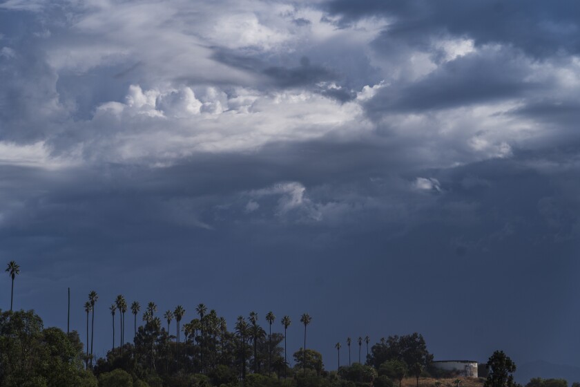 Cloud formations move over Elysian Park overlooking the San Gabriel Mountains in Los Angeles, Wednesday, June 22, 2022. (AP Photo/Damian Dovarganes)
