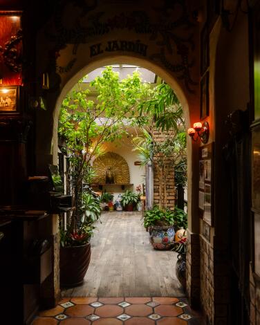 An arched doorway leads to a restaurant courtyard.