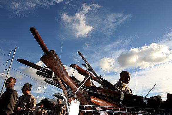 Some of the 300 weapons turned in Tuesday at Lennox Middle School fill a shopping cart. The Sheriffs Departments Gifts for Gun event continues today from 10 a.m. to 4 p.m. at the school. Donors receive $100 gift cards from Ralphs supermarket, Food 4 Less or Target.