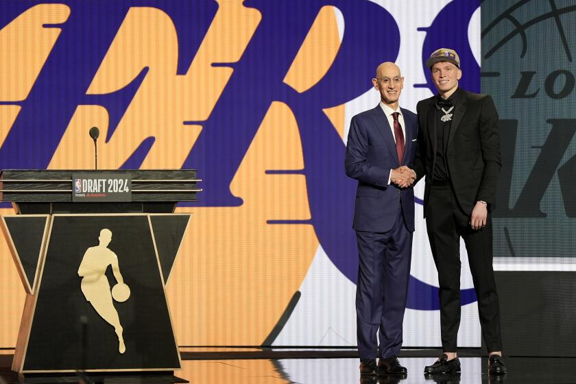 Dalton Knecht, right, poses for a photo with NBA commissioner Adam Silver after being selected 17th by the Los Angeles Lakers during the first round of the NBA basketball draft, Wednesday, June 26, 2024, in New York. (AP Photo/Julia Nikhinson)