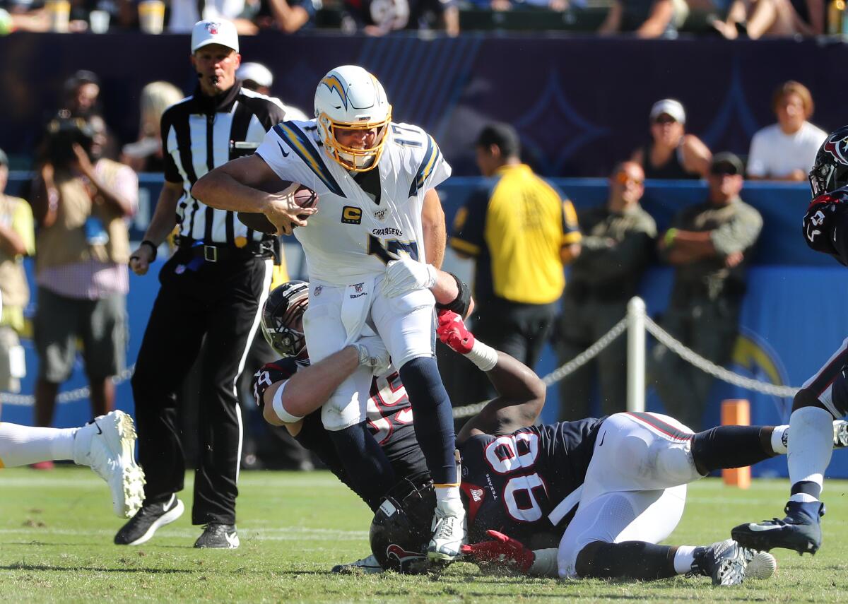 Chargers quarterback Philip Rivers is sacked by Houston Texans defensive end J.J. Watt.