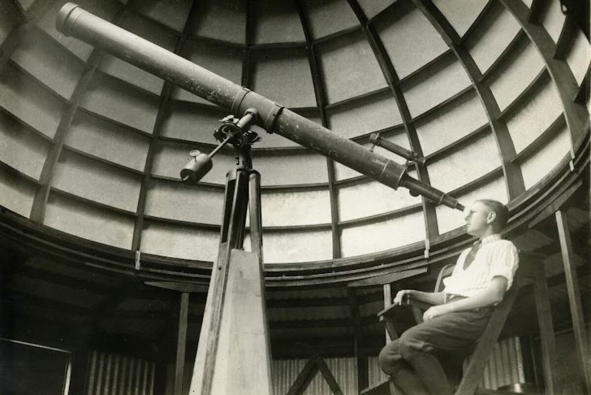 A student looks through a telescope in the Normal School's observatory in 1915.