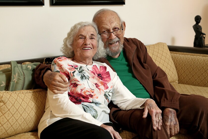 Serene and Sid Stokes, both 92, smile for a portrait at their home in Newport Beach.