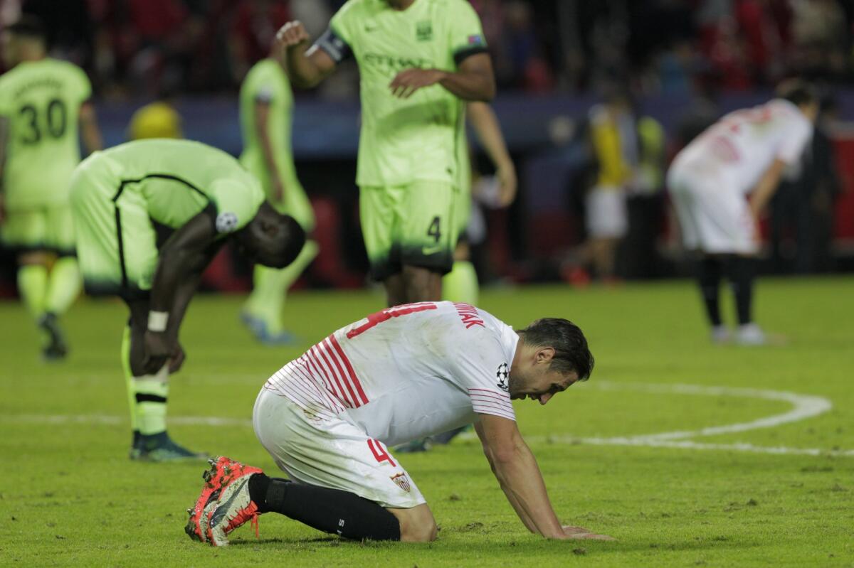 Sevilla's Grzegorz Krychowiak sinks to his knees at the end of the Group D Champions League soccer match between Sevilla and Manchester City at the Ramon Sanchez-Pizjuan stadium in Seville, Spain, Tuesday Nov. 3, 2015. Manchester City won the match 3-1. (AP Photo/Miguel Angel Morenatti)
