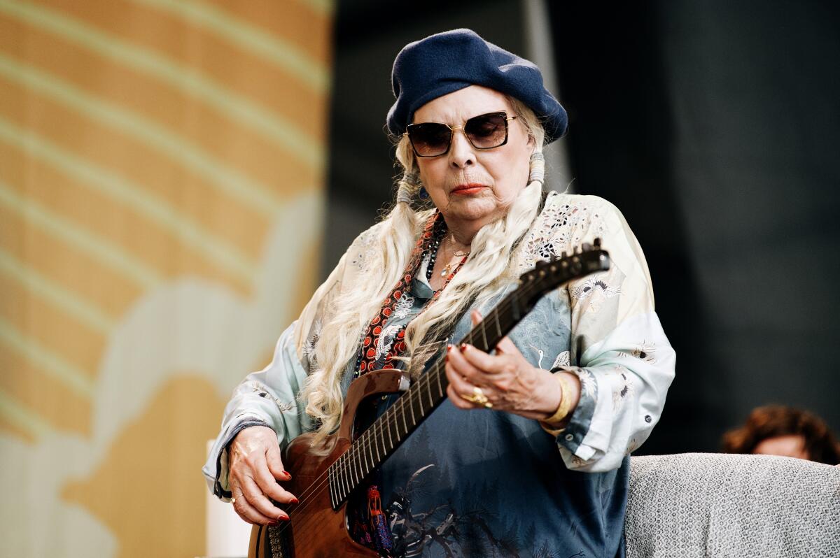 Joni Mitchell performs in a surprise appearance at the Newport Folk Festival in Newport, R.I., on Sunday.