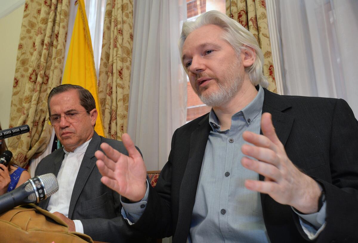 Ecuadorean Foreign Minister Ricardo Patino, left, and WikiLeaks founder Julian Assange speak during an Aug. 18, 2014, news conference inside the Ecuadorean Embassy in London.