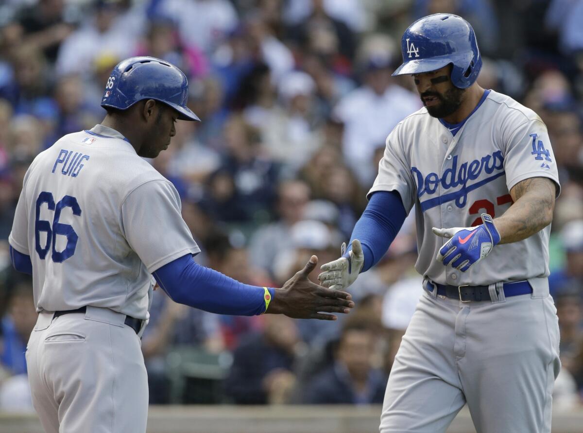 Matt Kemp celebrates with Yasiel Puig after hitting a two-run home run in the third inning of the Dodgers' 8-5 win over the Chicago Cubs on Sunday at Wrigley Field.
