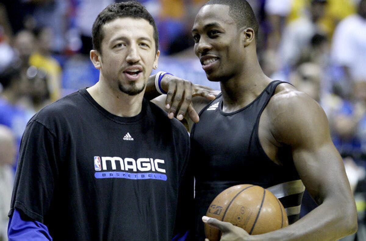 In 2009, Orlando teammates Hedo Turkoglu and Dwight Howard talk before a game against the Lakers in the NBA Finals.