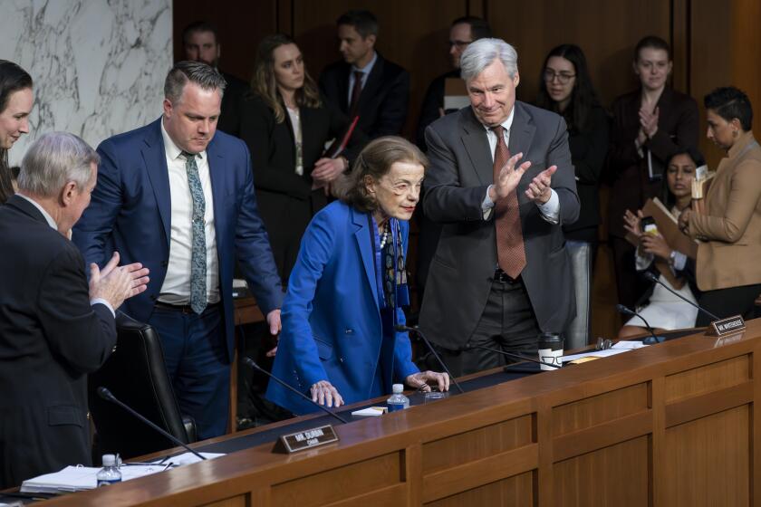 Sen. Dianne Feinstein, D-Calif., is welcomed back to the Senate Judiciary Committee with applause from Senate Judiciary Committee Chairman Dick Durbin, D-Ill., left, and Sen. Sheldon Whitehouse, D-R.I., right, following a more than two-month absence as she was being treated for a case of shingles, at the Capitol in Washington, Thursday, May 11, 2023. (AP Photo/J. Scott Applewhite)