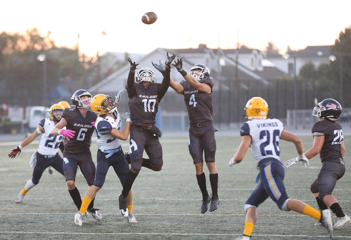 Jacob Carlon (10) attempts to catch a deflected punt with Carson De Avila (4), which later led to a score against Marina.