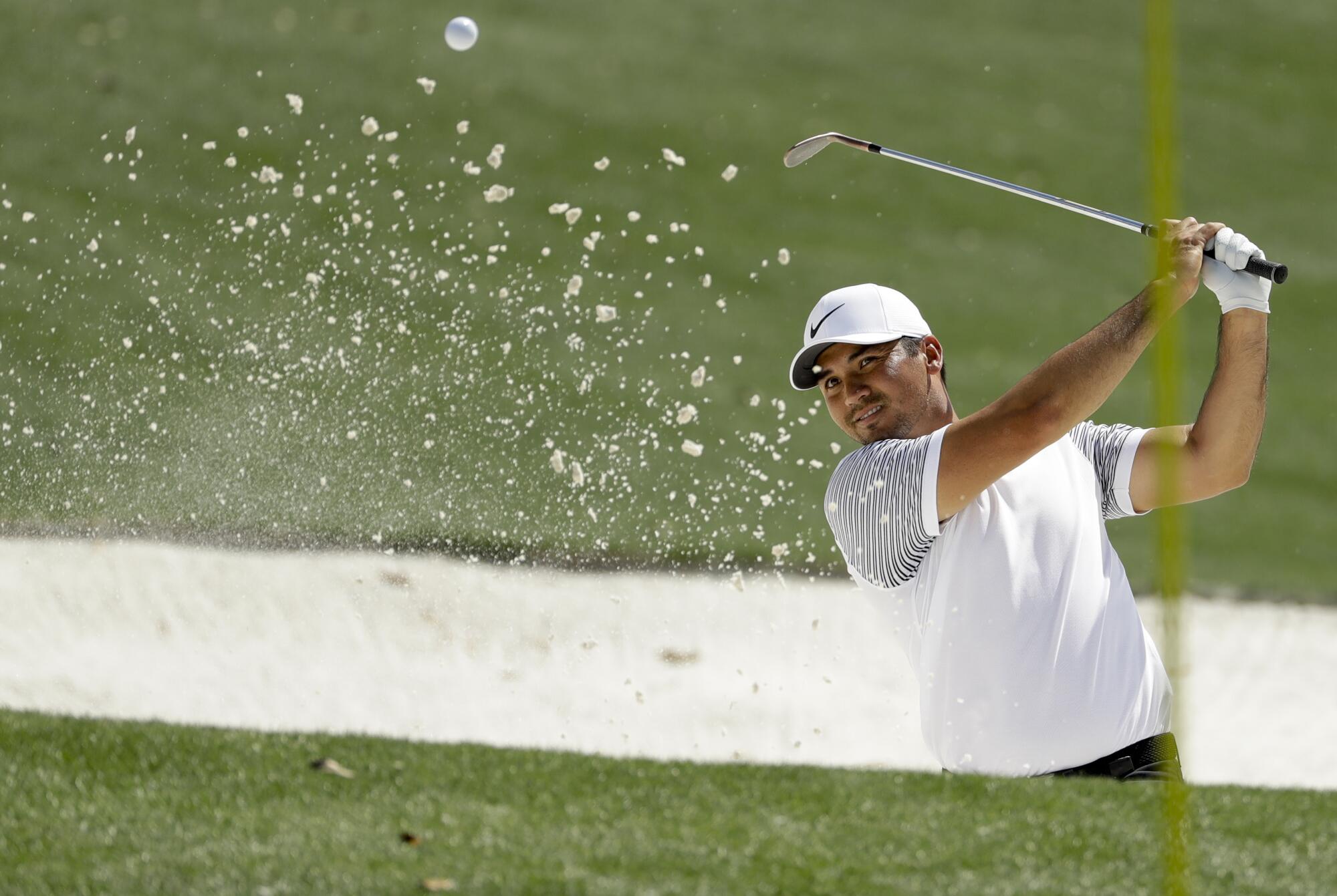 Jason Day hits out of the bunker on the 18th hole during practice for the Masters April 3, 2018, at Augusta National