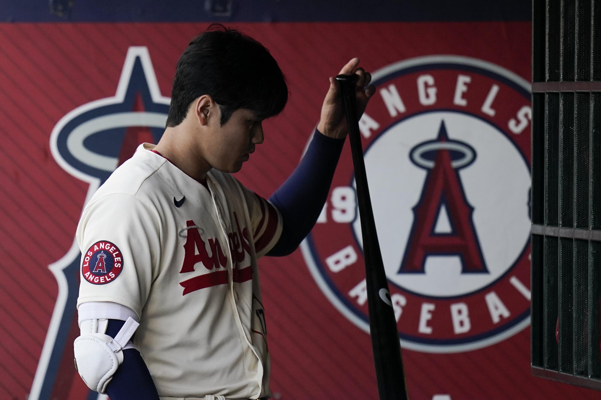 Angels two-way star Shohei Ohtani grabs his bat during a game.