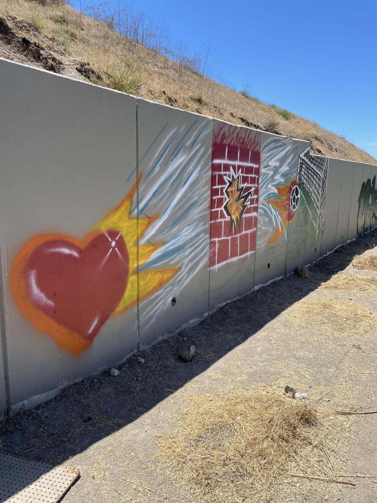 Some of the children have been painting the stone walls along the perimeter of the library.