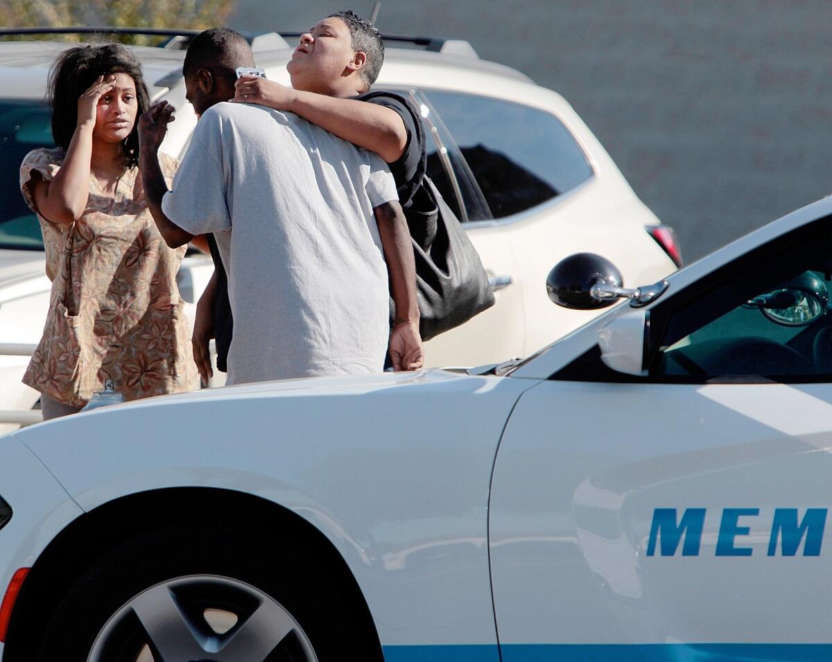 People wait outside the Regional Medical Center in Memphis, Tenn. Memphis Police Director Toney Armstrong said Memphis police officer Terence Olridge was killed after being shot multiple times while off duty on Sunday.