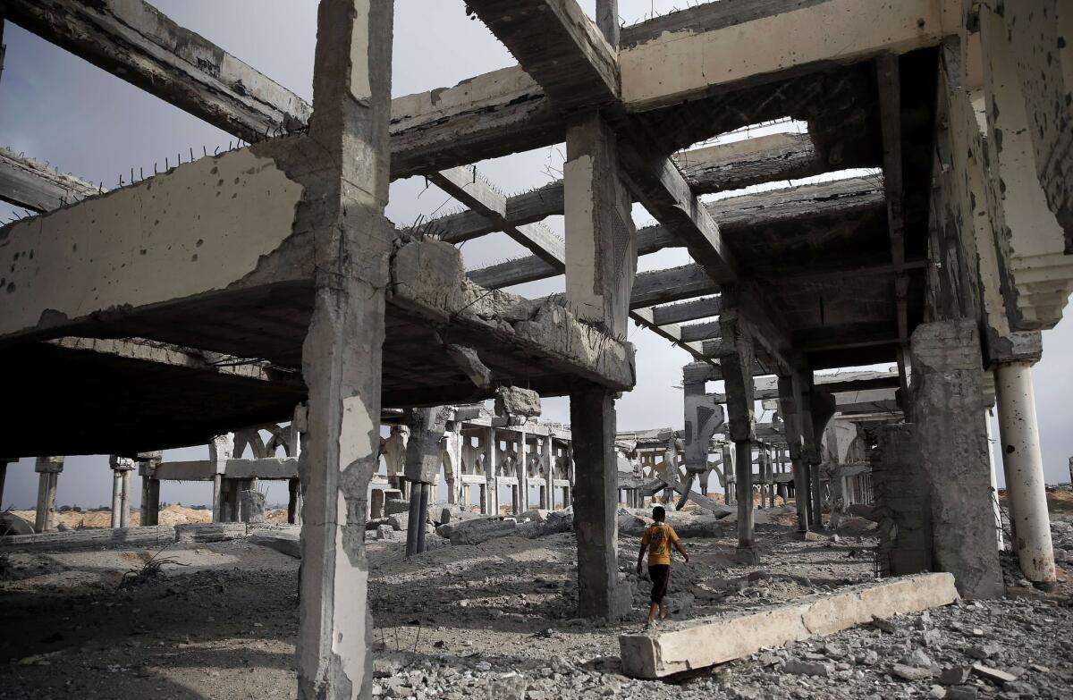 A Palestinian boy makes his way through the destroyed terminal of the Gaza Strip's former international airport in the southern city of Rafah on Aug. 18.