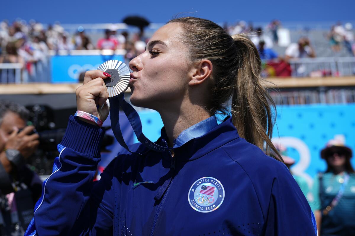 American Nevin Harrison kisses her silver medal after the women's canoe single 200-meter final on Saturday.