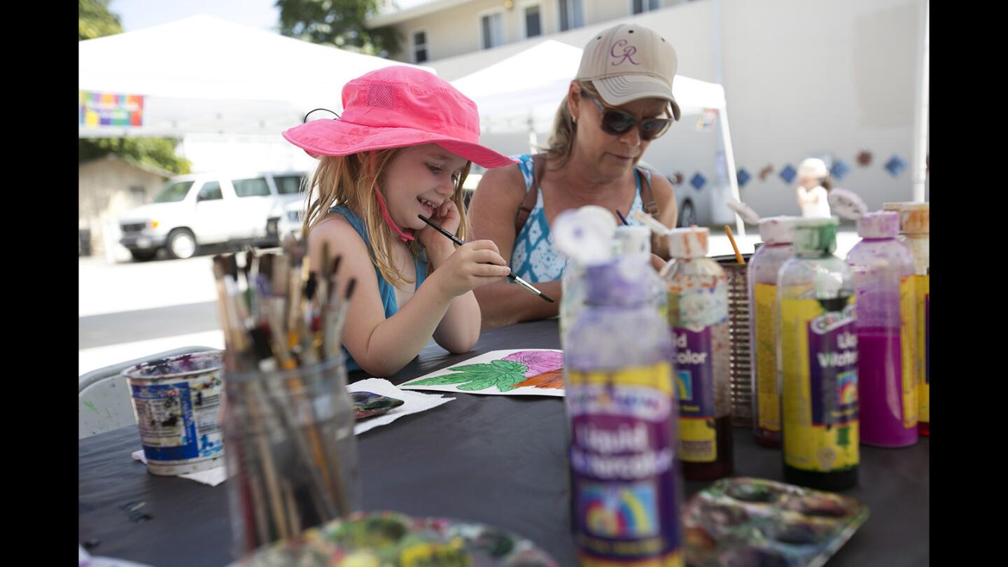 Hayley June, left, and Sherry Gonzalez paint water color paintings during the 2nd Annual Art in the Park Festival at Triangle Park in Huntington Beach on Saturday, August 26.