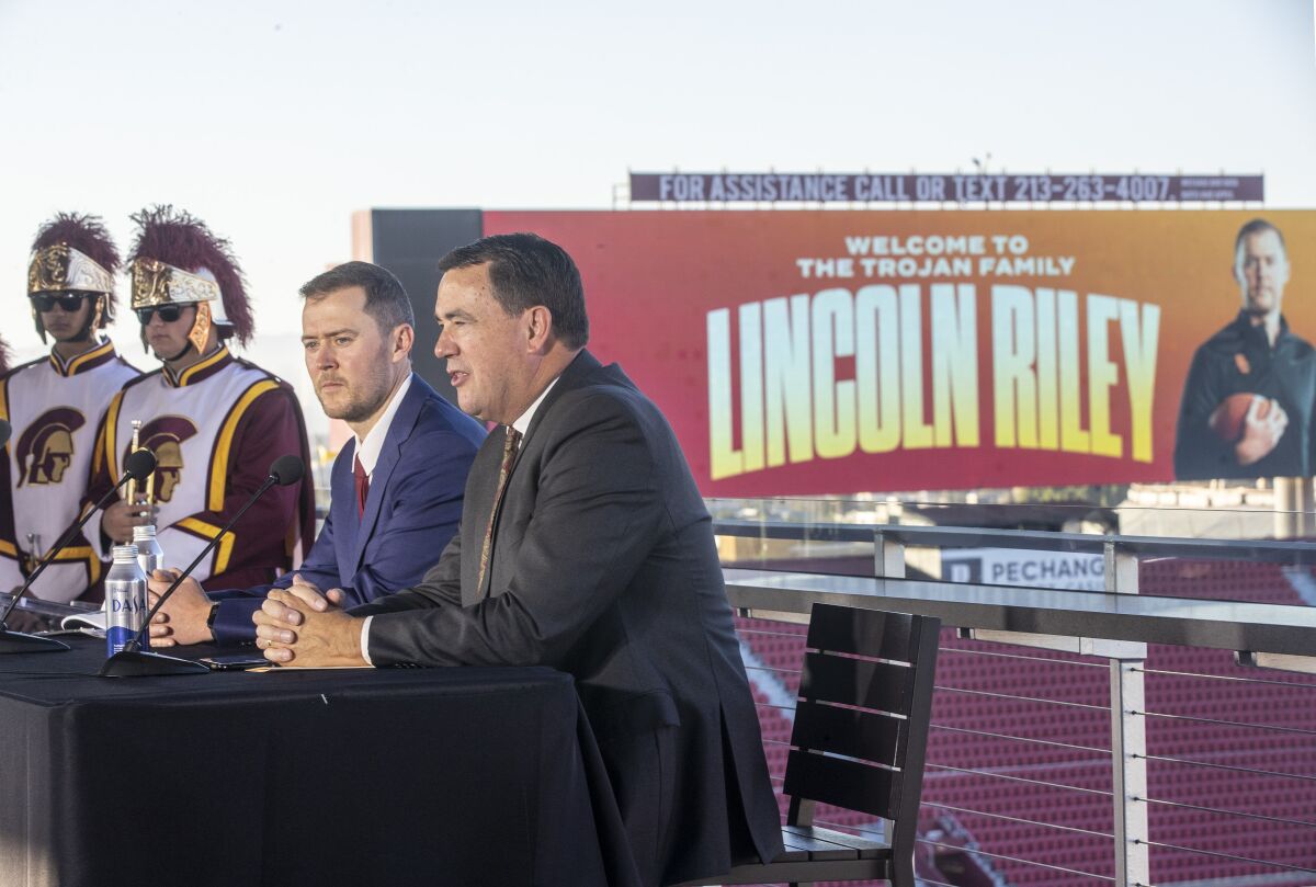 USC coach Lincoln Riley, left, and USC Athletic Director Mike Bohn take part in a news conference.