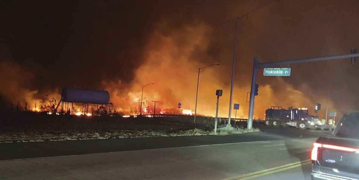 Fire and orange-illuminated smoke fill the sky