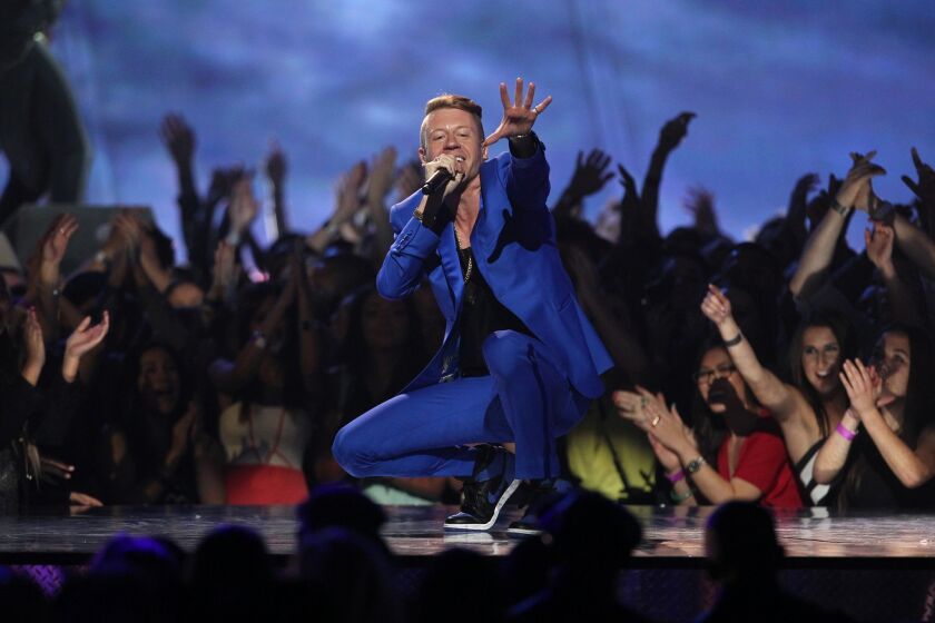 FILE - In this April 14, 2013 file photo, Macklemore performs "Can't Hold Us" at the MTV Movie Awards in Sony Pictures Studio Lot in Culver City, Calif. (Photo by Matt Sayles/Invision /AP)