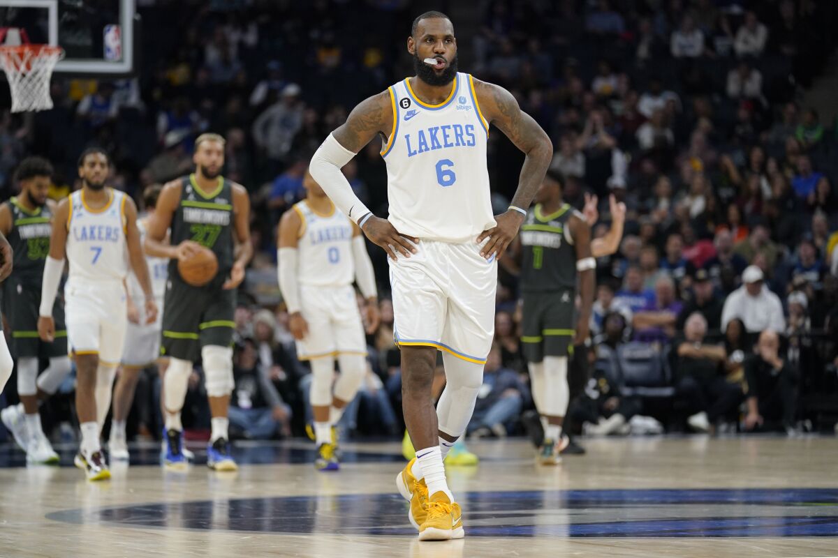 Lakers forward LeBron James walks on the court during the final minute of a 111-102 loss to the Minnesota Timberwolves.