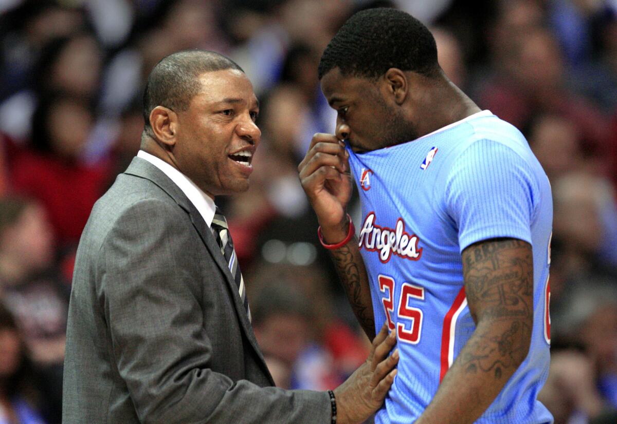 Clippers Coach Doc Rivers talks with guard Reggie Bullock during a November game with the Bulls at Staples Center.