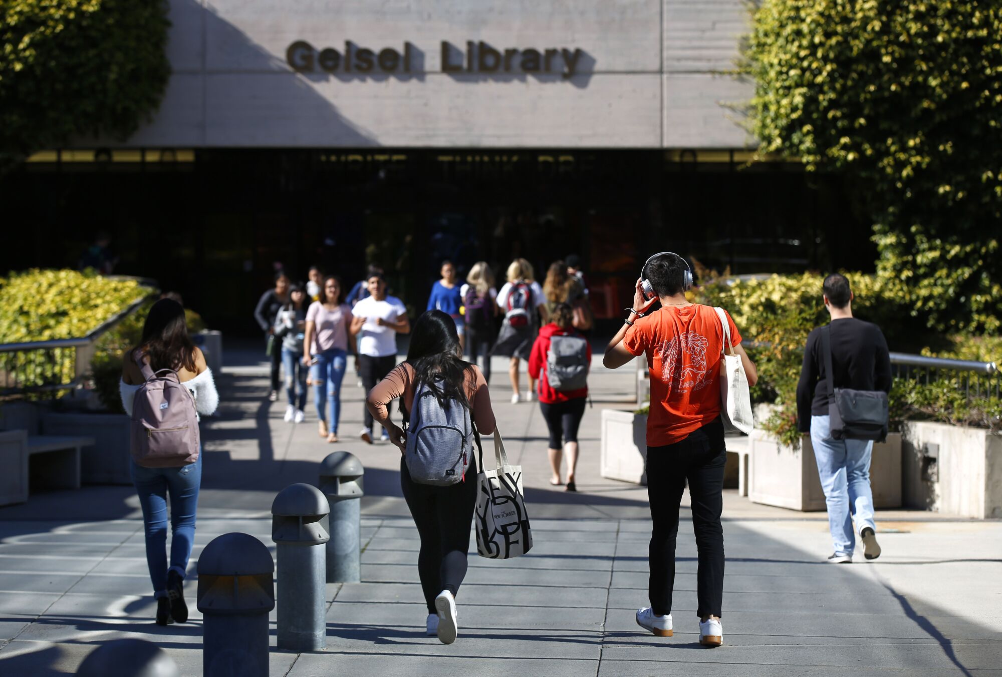 UC San Diego students walk to Geisel Library at the school on April 24, 2019.