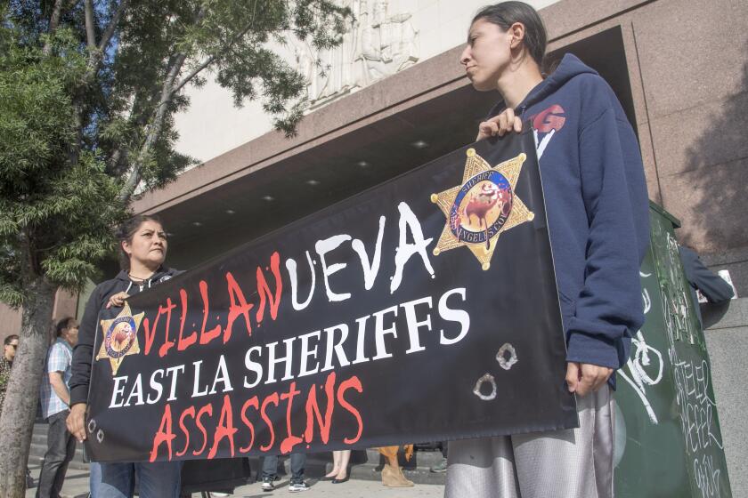 Los Angeles, CA - August 16, 2019 - Valerie Vargas, left and Stephanie Luna, both aunts of Anthony Vargas who wash shot and killed by sheriff's deputies in 2017, join a rally in front of the Stanley Mosk Courthouse on Friday to call for more checks and balances on the sheriff's department.The rally was held before a hearing on a lawsuit against Sheriff Alex Villanueva for reinstating a deputy previously fired for domestic violence. (Ana Venegas / For The Times))