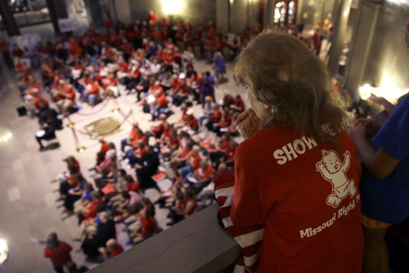 Elizabeth War looks over a gathering of her fellow abortion opponents in the Missouri Capitol rotunda Wednesday, where lawmakers overrode a veto by Gov. Jay Nixon of legislation requiring a 72-hour waiting period for abortions.