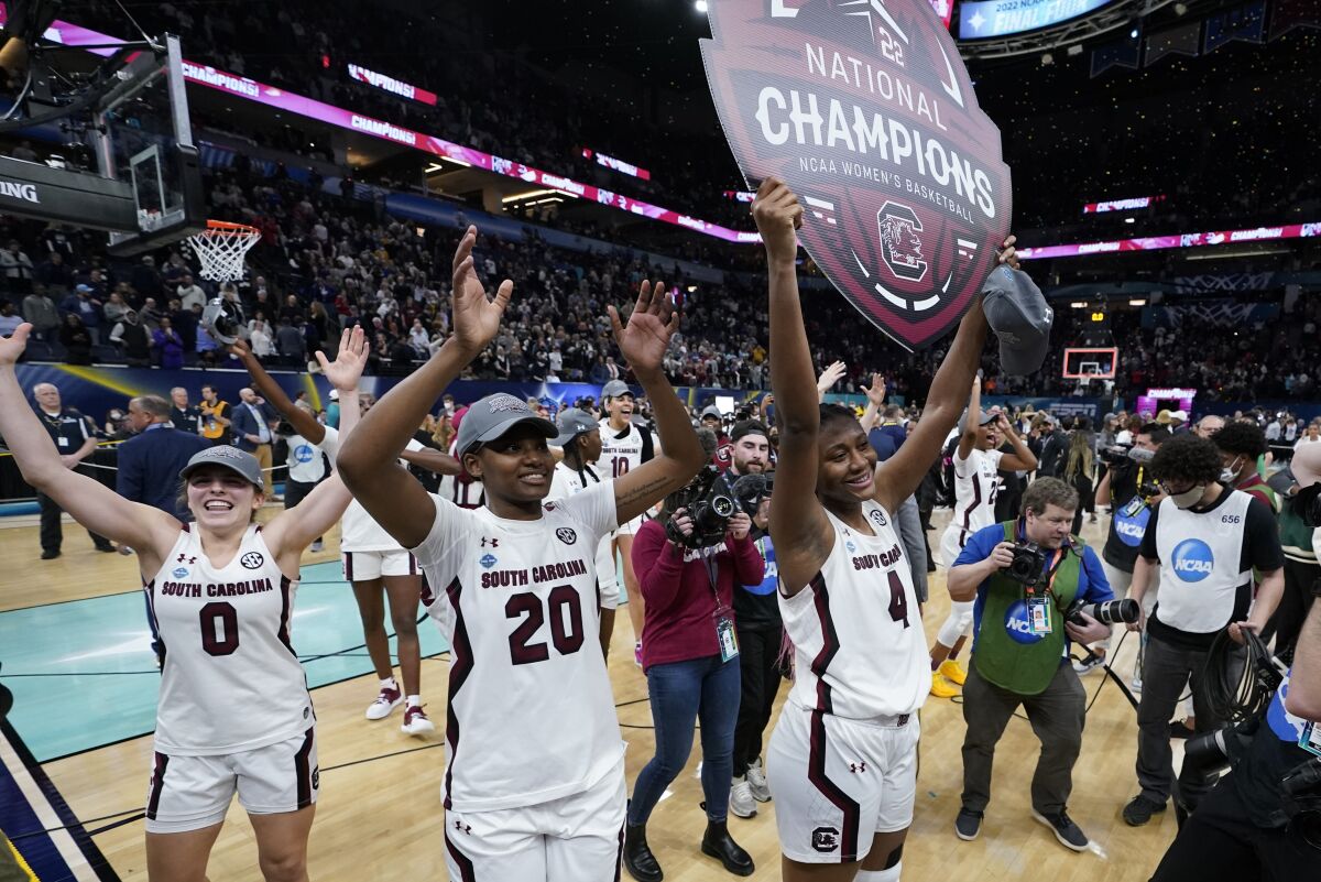South Carolina players celebrate after a college basketball game in the final round.