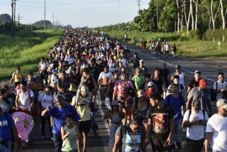 Migrants walk along the highway through Suchiate, Chiapas state in southern Mexico, Sunday, July 21, 2024, during their journey north toward the U.S. border. (AP Photo/Edgar H. Clemente)