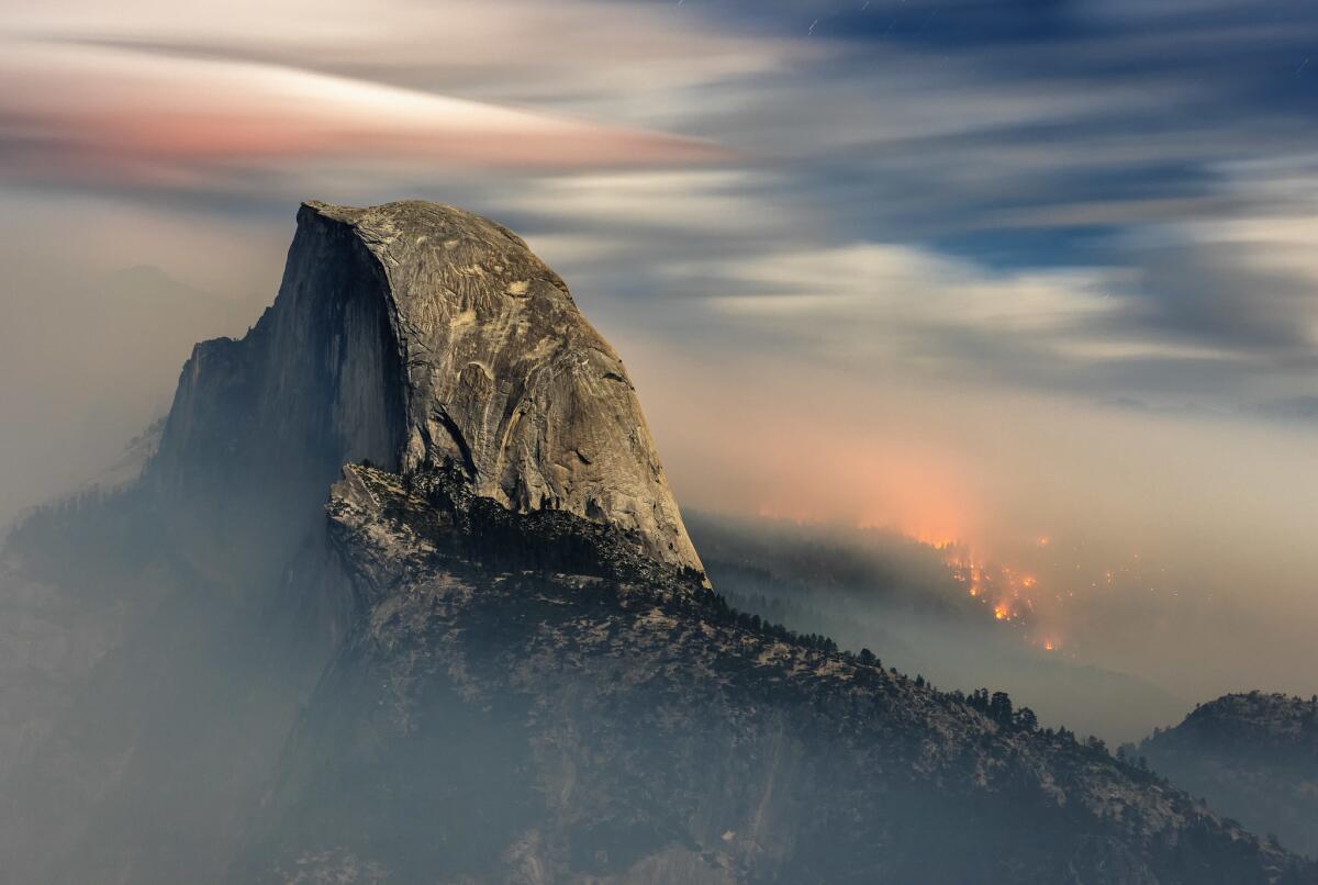 The Meadow fire burns behind Half Dome in Yosemite National Park shortly before dawn in September 2014.