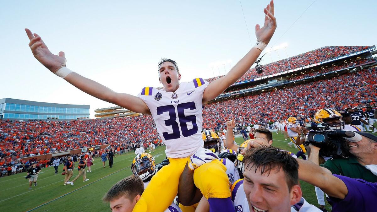 LSU kicker Cole Tracy celebrates with teammates after kicking the game-winning field goal in their 22-21 win over Auburn on Saturday.