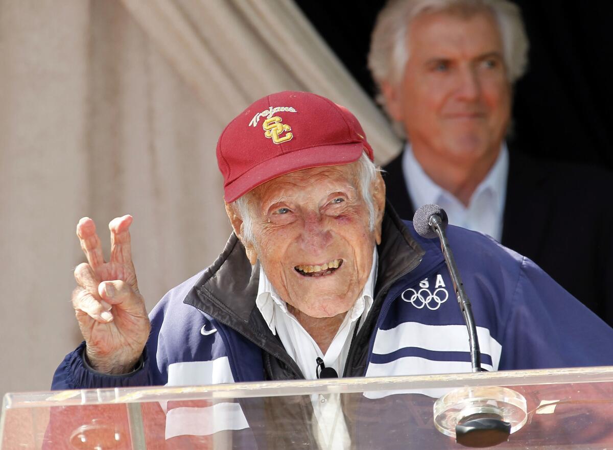 Louis Zamperini gestures during a news conference on May 9, 2014, in Pasadena, where he was announced as the 2015 Rose Parade grand marshal.