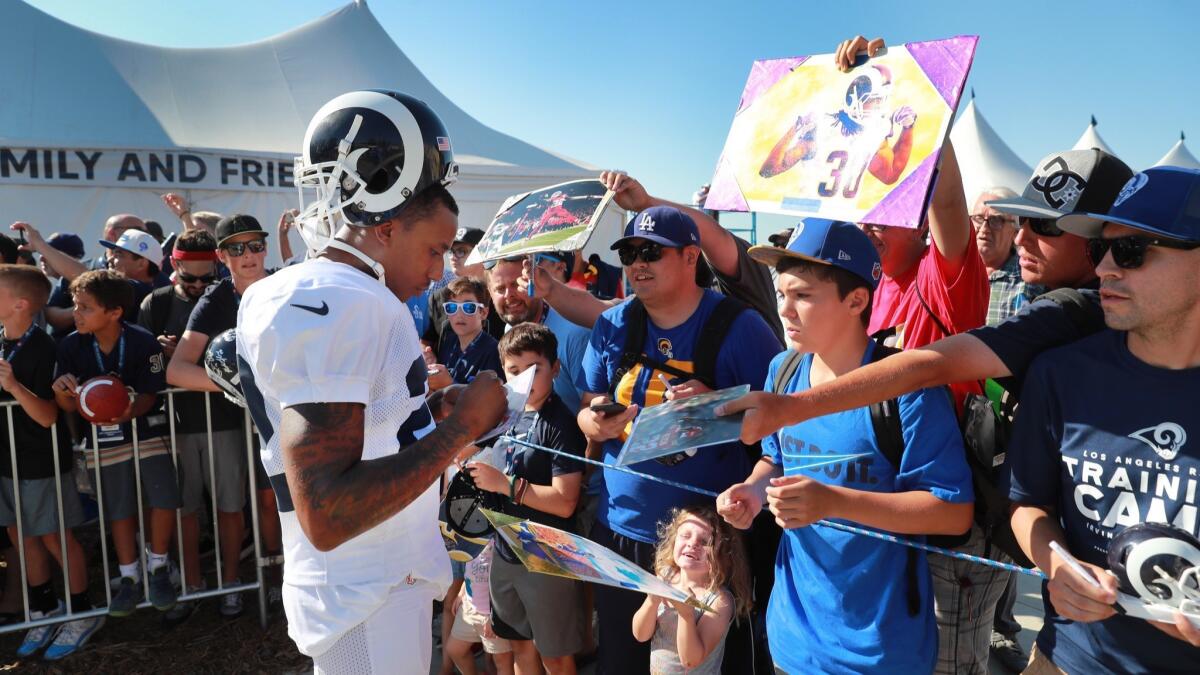 Rams corner back Marcus Peters signs autographs for fans during the Los Angeles Rams training camp at UC-Irvine on Aug. 13.