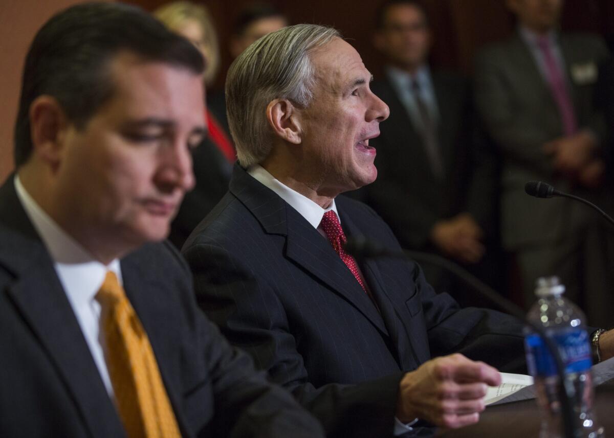 Texas Gov. Greg Abbott, left, and Sen. Ted Cruz discuss legislation addressing the Obama administration's effort to resettle Syrian refugees.