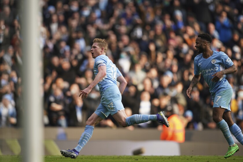 Manchester City's Kevin De Bruyne, left, reacts after celebrates after scoring the opening goal during an English Premier League soccer match between Manchester City and Chelsea at the Etihad stadium in Manchester, England, Saturday, Jan. 15, 2022. (AP Photo/Dave Thompson)