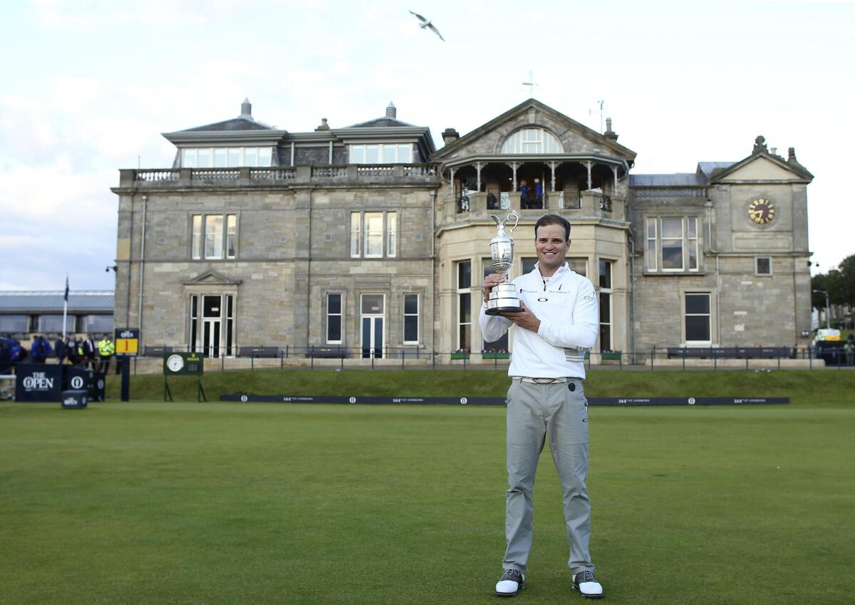 Zach Johnson poses with the trophy after winning the British Open Golf Championship at the Old Course in St. Andrews, Scotland.