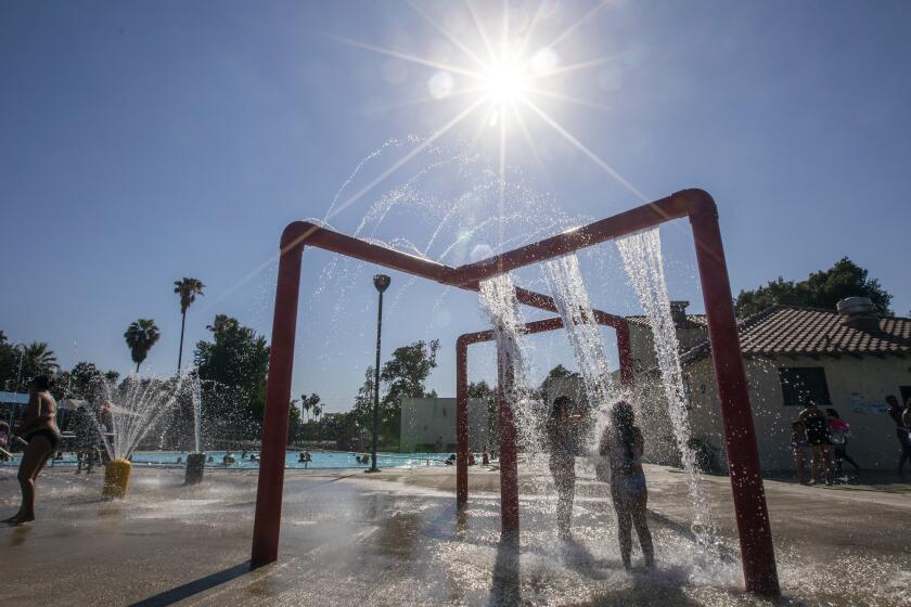 SAN BERNARDINO, CA - JUNE 25: Children cooling down at the Jerry Lewis Family Swim Center in San Bernardino, CA on Friday, June 25, 2021. It's currently 94 degrees here and it's expected that the temperature will increase over the next few days. (Francine Orr / Los Angeles Times)