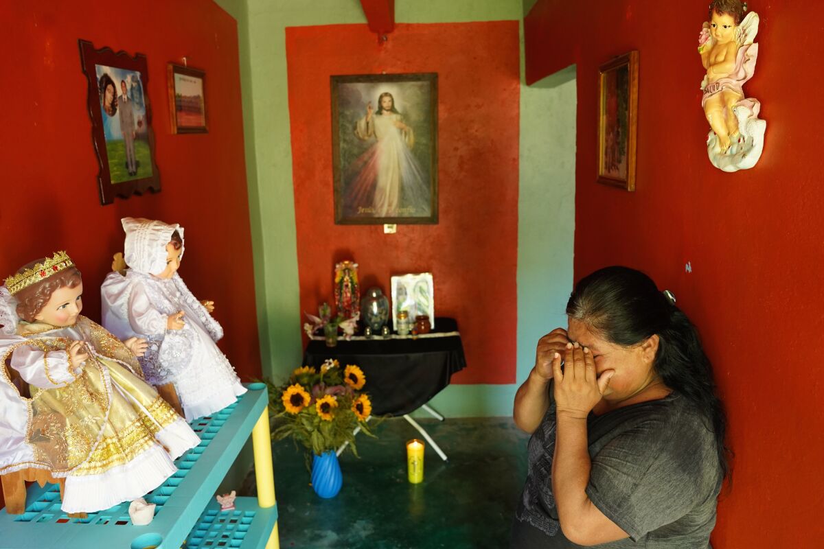 Isabel Baez Vaquero, 54, mourns her husband, Benito Medardo Tlatelpa Calixto, 55, at their home in Ahuehuetitla, Mexico. 