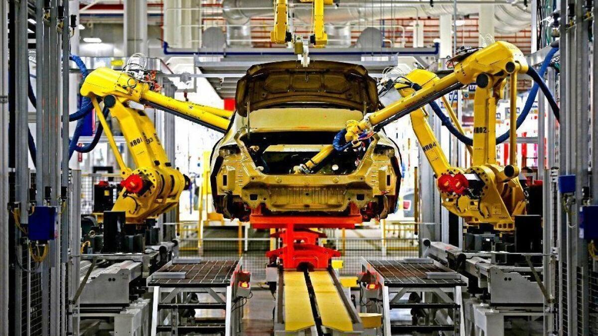 Robots build a Chrysler vehicle at the Sterling Heights Assembly Plant in Michigan in 2014.
