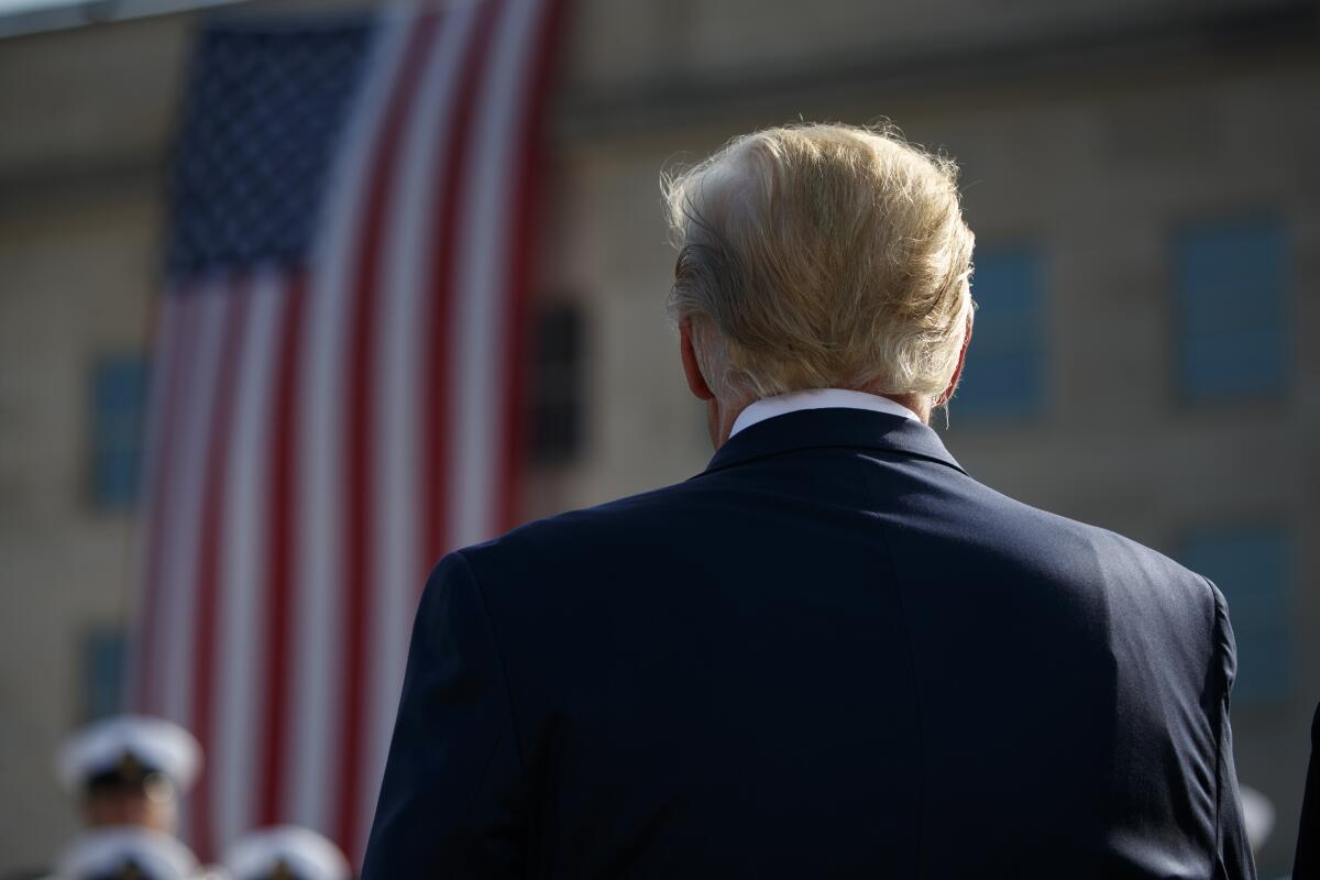 President Trump stands for the national anthem during a ceremony honoring the victims of Sept. 11. 